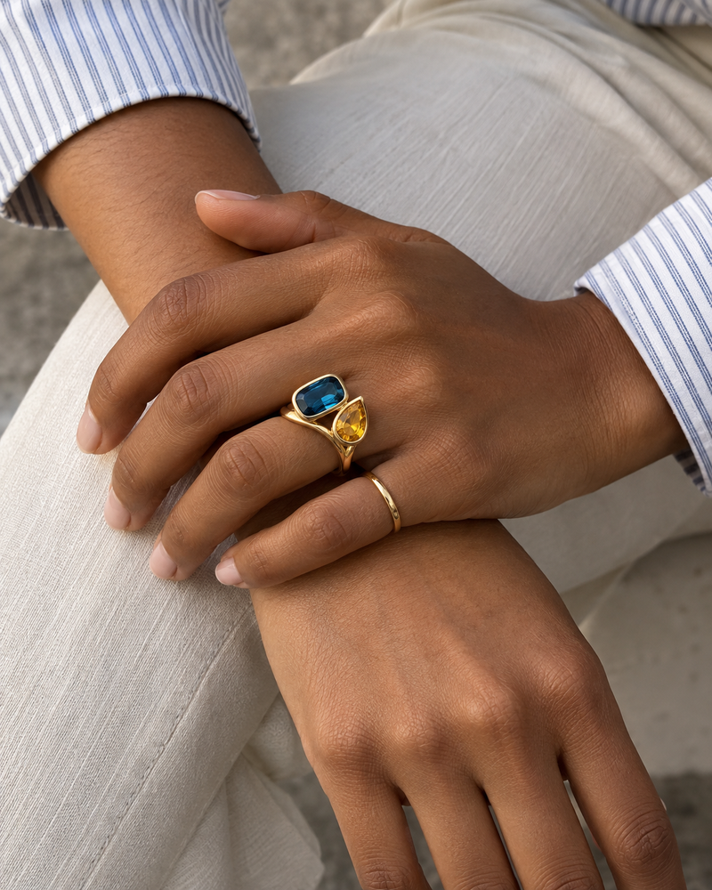 AI design reference: a model wearing a blue topaz and golden citrine two-stone ring.